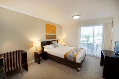 سرير أو أسرّة في غرفة في Gladstone City Central Apartment Hotel Official