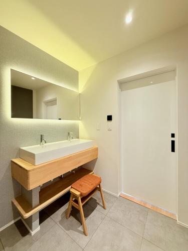 a bathroom with a sink and a mirror at The Lobs Toya, Chalet Secca in Lake Toya