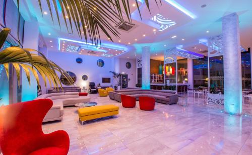 a living room with couches and chairs and avisor at Nicholas Color Hotel in Ayia Napa