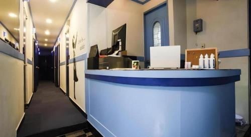a lobby with a blue counter in a building at W Mini Hotel in Seoul
