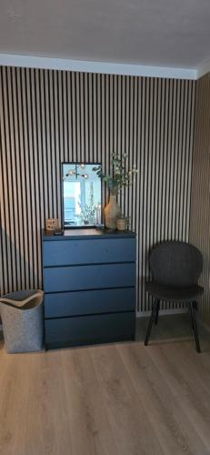 a dresser with a mirror and a chair in a room at Modern apartment Sunndalsøra city center - Balcony in Sunndalsøra