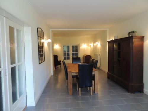 a dining room with a table and chairs at Lindenhof in Grömitz