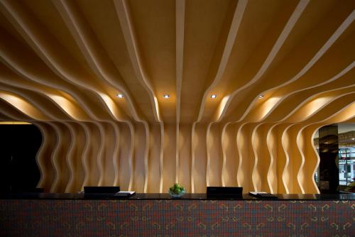 a conference room with a wall made of wooden panels at Venue Hotel in Singapore