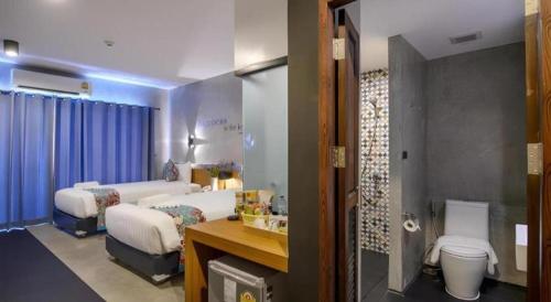 a hospital room with two beds and a bathroom at B2 Krabi Premier Hotel in Ao Nang Beach