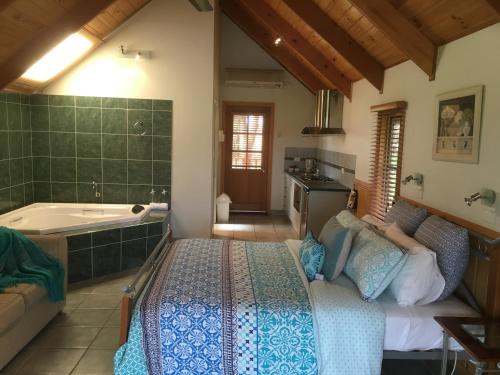 a bedroom with a bed and a bath tub at Colac Colac Caravan Park in Corryong
