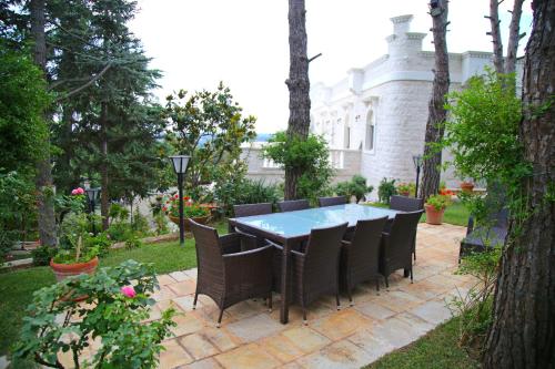 a patio with a table and chairs in a yard at Villa Angelina in Selva di Fasano