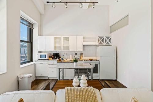 a kitchen with white cabinets and a table at CBD Apartment Pool 24-7 Gym Parking in Cincinnati