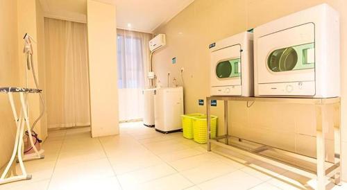 a hospital room with two refrigerators and a kitchen at City Comfort Inn Beihai Hepu Bus Terminal in Beihai