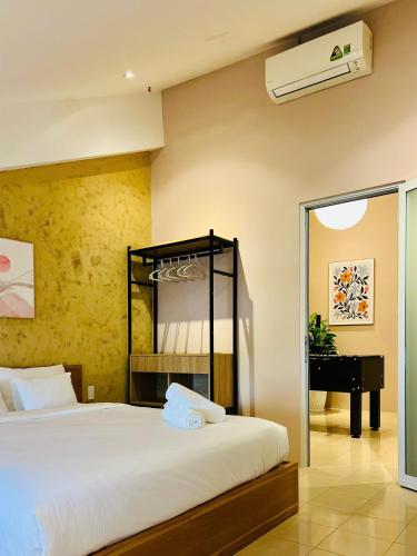 a bedroom with a bed with a mirror and a piano at TUNs House - Central 3BRs near Ben Thanh Market in Ho Chi Minh City