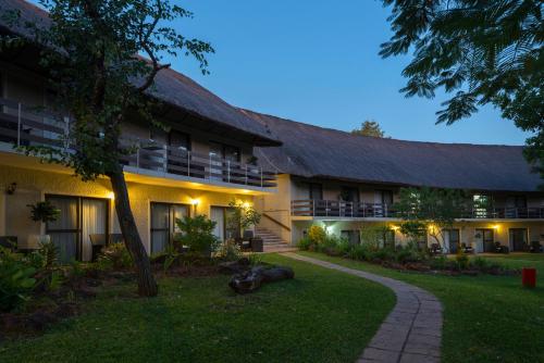 an exterior view of a building at night at Azambezi River Lodge in Victoria Falls
