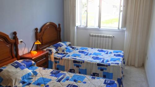 En eller flere senge i et værelse på Apartamento con balcón al lado de la iglesia