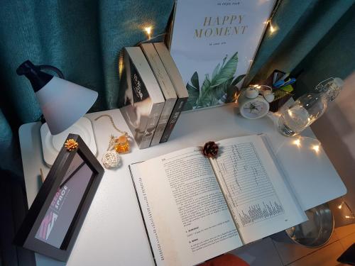 an open book on a desk with books at Rent Space Coliving Bandar Hilir Melaka in Melaka