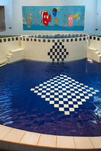 a swimming pool with a checkered floor in the water at فندق السعادة in Al Qarn