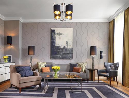 a living room with a couch and a table at Corinthia Budapest in Budapest