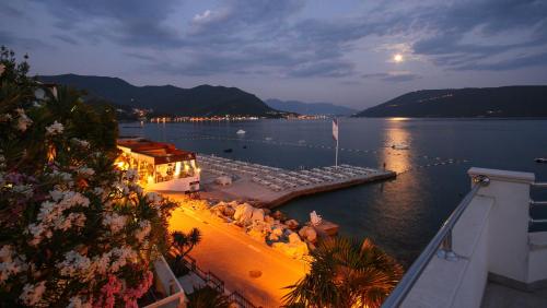 a view of a large body of water at night at Hotel Perla in Herceg-Novi