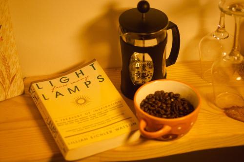 a book and a cup of coffee on a table at Odd Table Stay and Experiences in Mandrem