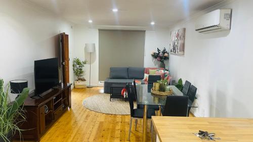 a living room with a couch and a table at House in Sunshine close to city in Sunshine