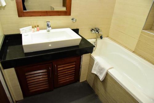 a bathroom with a sink and a bath tub at cockpit tower at colombo airport in Katunayake