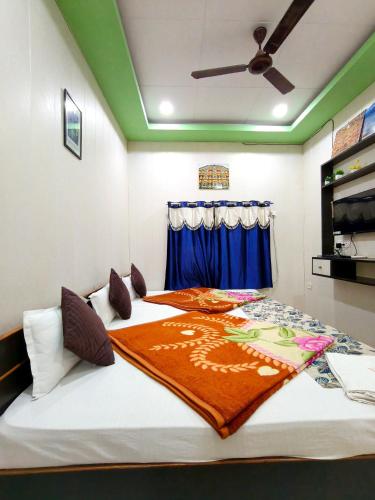 a large bed in a room with a ceiling fan at Golden River Homestay in Varanasi