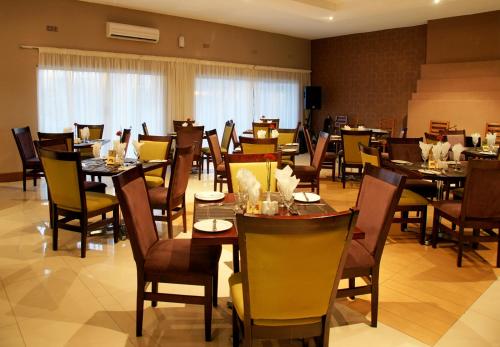 a dining room filled with tables and chairs at Kadoma Hotel & Conference Centre in Katoma