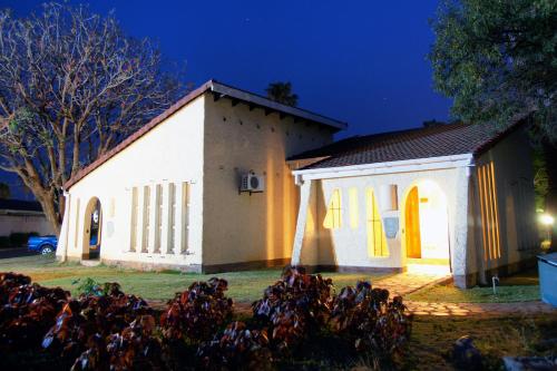 a small white church at night at Kadoma Hotel & Conference Centre in Katoma