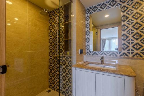 a bathroom with a sink and a mirror at C240 New Prime Location 1BR Condo Near Beach Club in Thalang