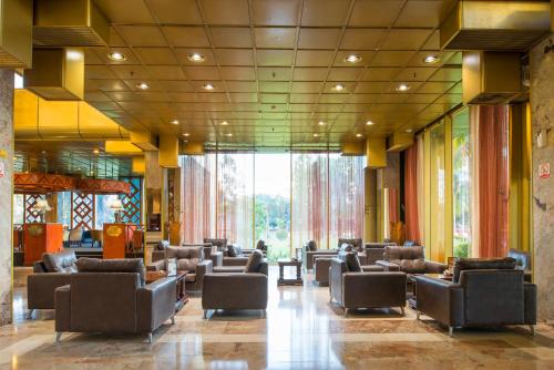 a waiting room with couches and chairs in a building at Rainbow Towers Hotel & Conference Centre in Harare