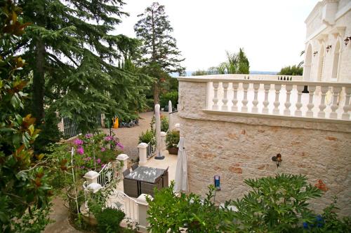a garden with a white fence and a building at Villa Angelina in Selva di Fasano
