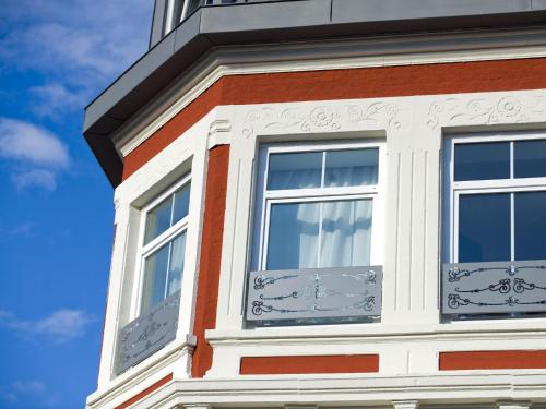 a building with two windows on the side of it at B&B HOTEL Dunkerque Centre Gare in Dunkerque