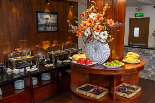 a buffet in a hotel room with food on a table at A25 Hotel - 29 Lê Thị Hồng Gấm in Ho Chi Minh City