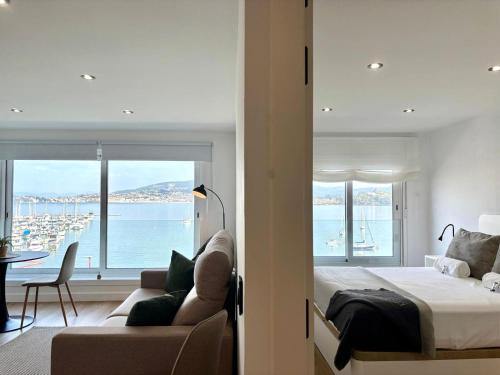 a bedroom with a bed and a view of the water at Holibai, Meiga Do Mar, Apto moderno, vistas al mar y playa cerca, Baiona in Baiona