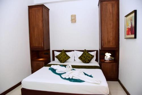 a bedroom with a bed with white towels on it at cockpit tower at colombo airport in Katunayake