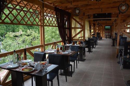 a dining room with tables and chairs in a building at Guest House Albatros in Cholpon-Ata