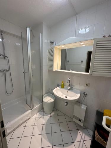 a bathroom with a shower toilet and a sink at Knechtsand 402 in Cuxhaven