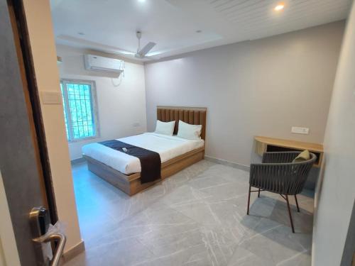 a bedroom with a bed and a desk and a chair at VIAN INN in Guwahati