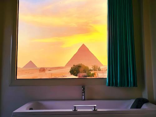 a bathroom with a painting of the pyramids at Pyramids New Gate HoteL & Restaurant in Cairo