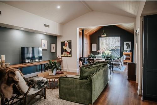 a living room with a couch and a table at Olive Cottage Rankin in Bathurst