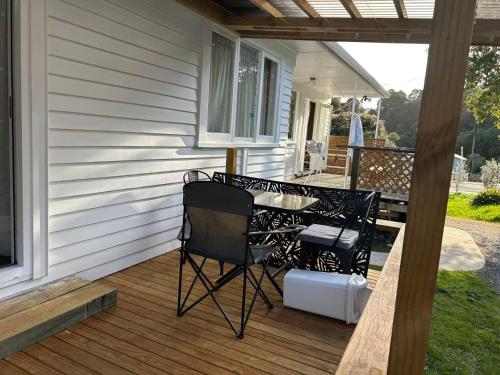 a patio with two chairs and a table on a porch at 13 Bedlington in Whangarei