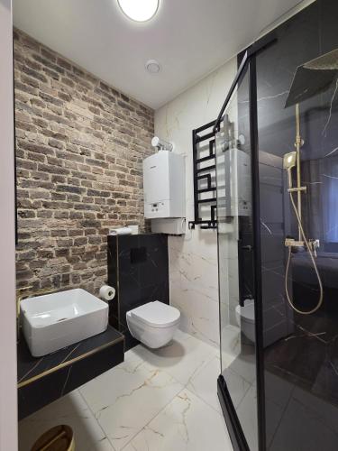 a bathroom with a toilet and a sink and a shower at Placeo in Katowice