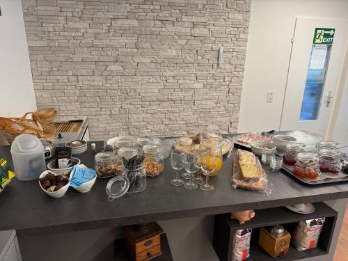 Un mostrador con comida y vasos sobre una mesa. en Bergnest Wildhaus, en Wildhaus