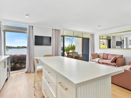 a kitchen and living room with a view of the ocean at Yarrawonga Lakeside Apartment 25 in Mulwala