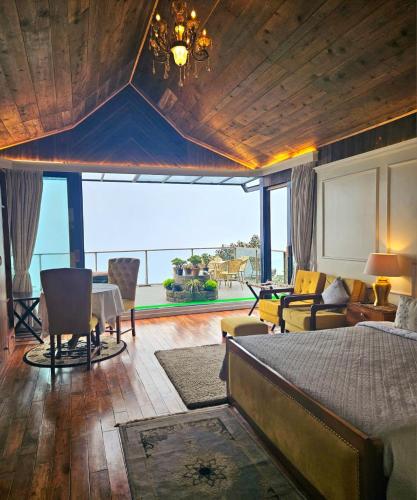 a bedroom with a bed and a view of the ocean at THE ENGLISH COTTAGE in Darjeeling