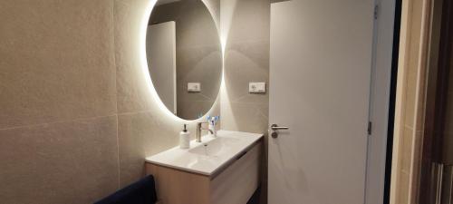 a bathroom with a sink and a mirror at El rincón verde de David y Laura in O Porto de Espasante