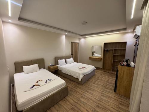 Ένα ή περισσότερα κρεβάτια σε δωμάτιο στο Pyramids View Makani Hotel