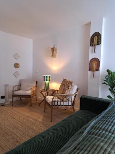 a bedroom with a bed and a table and chairs at Casa do Logradouro in Alcochete