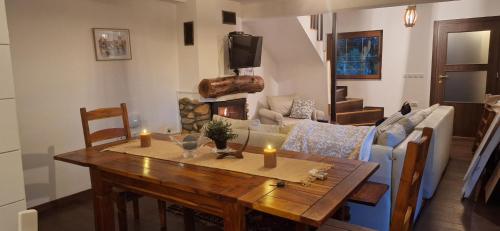 a living room with a table and a fireplace at Beloviski raj 