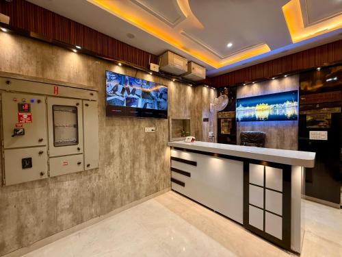 a lobby with a bar and a tv on the wall at Hotel KABIR ROYAL in Amritsar