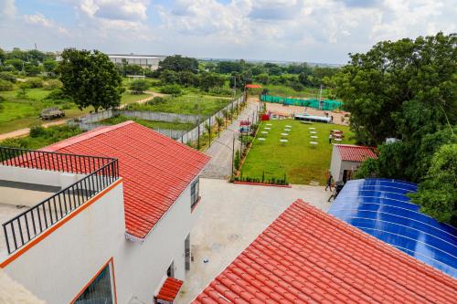 an overhead view of a playground with red roofs at SPK farmhouse in Medchal