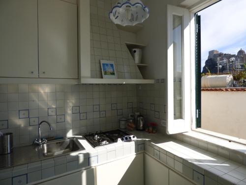 a kitchen with a sink and a window at Ella House in Ischia