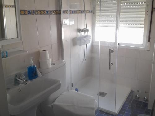 a bathroom with a shower and a toilet and a sink at A beautiful Townhouse in Rute